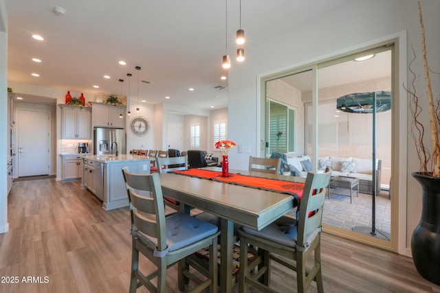 dining area featuring light wood finished floors and recessed lighting