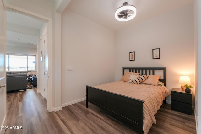 bedroom with baseboards and wood finished floors