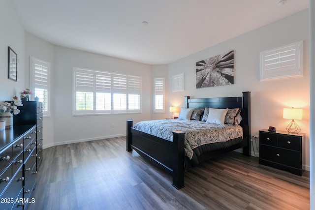 bedroom featuring dark wood finished floors and baseboards