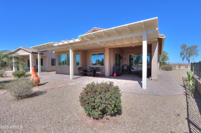 back of property featuring a pergola, stucco siding, fence, and a patio