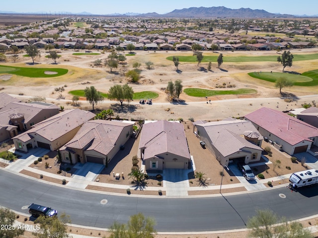 drone / aerial view with a residential view, a mountain view, and golf course view