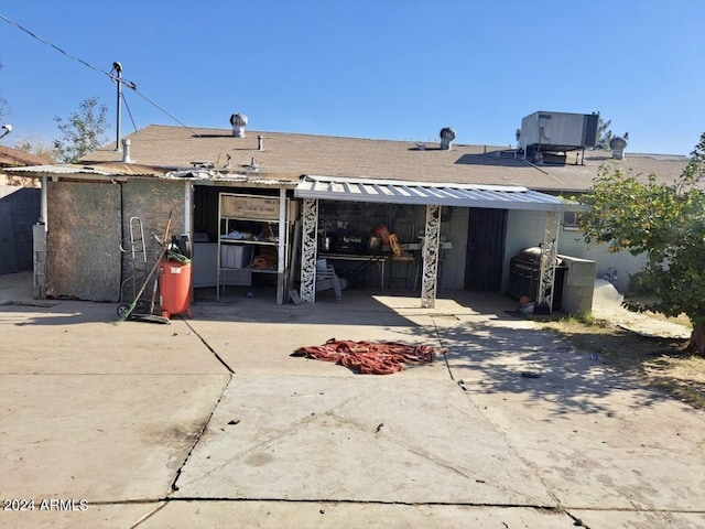 rear view of house featuring central AC