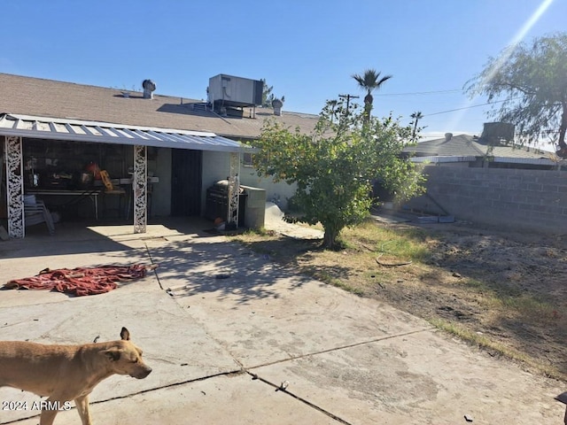 back of property featuring central AC