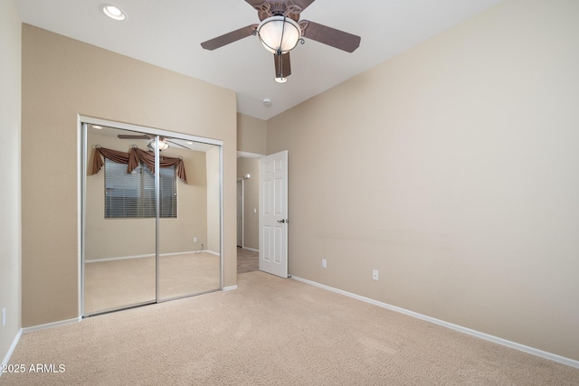 unfurnished bedroom featuring baseboards, carpet floors, recessed lighting, ceiling fan, and a closet