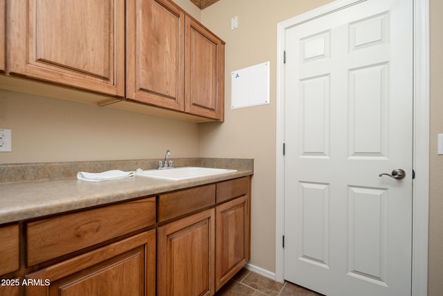 interior space featuring dark tile patterned flooring and a sink