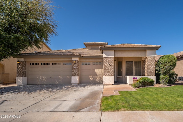 prairie-style home featuring brick siding, a tiled roof, stucco siding, a garage, and driveway