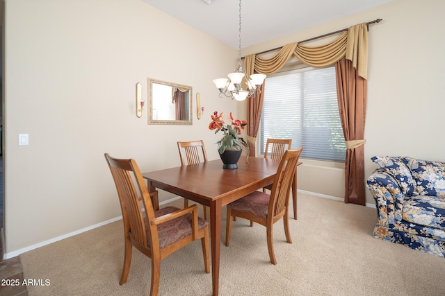 dining area with a notable chandelier, baseboards, and light carpet