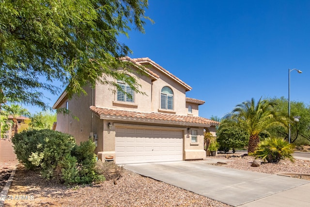 mediterranean / spanish-style house featuring a garage