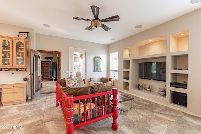 living room with ceiling fan and built in features