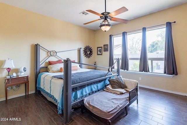 bedroom with dark wood-type flooring and ceiling fan