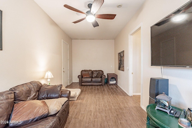 living room with ceiling fan and light hardwood / wood-style flooring