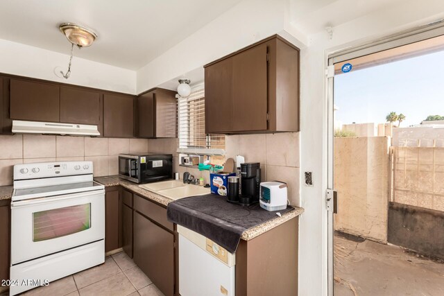 kitchen featuring dark brown cabinetry, sink, tasteful backsplash, white range with electric stovetop, and light tile patterned floors