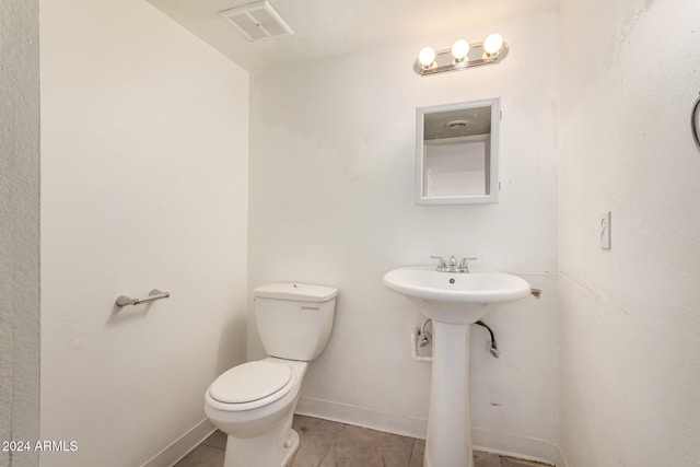 bathroom featuring tile patterned floors, toilet, and sink