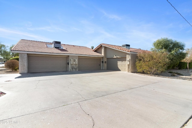 view of front of property featuring a garage and cooling unit