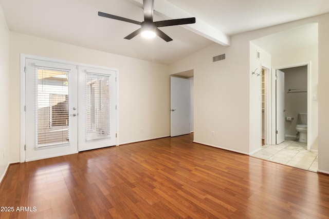 spare room with french doors, ceiling fan, light hardwood / wood-style floors, and vaulted ceiling with beams