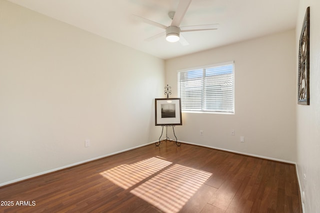 empty room featuring ceiling fan and dark hardwood / wood-style flooring