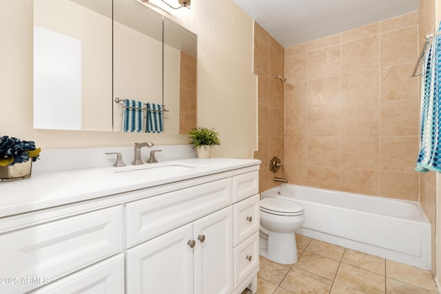 full bathroom featuring toilet, tile patterned flooring, tiled shower / bath combo, and vanity