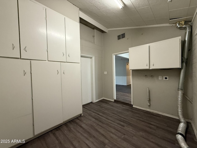 washroom with visible vents, hookup for a gas dryer, dark wood-type flooring, cabinet space, and electric dryer hookup