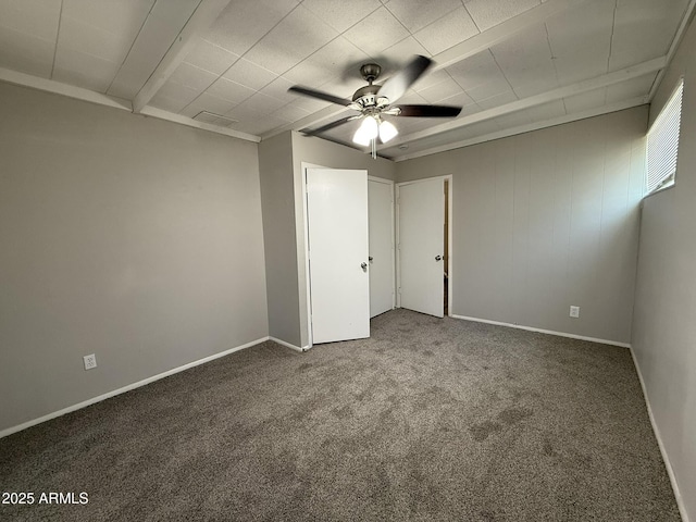 unfurnished bedroom featuring carpet flooring, baseboards, and ceiling fan