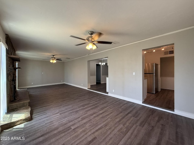 unfurnished living room featuring ceiling fan, crown molding, baseboards, and dark wood-type flooring