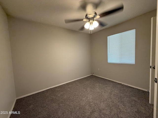 empty room with baseboards, a ceiling fan, and dark carpet