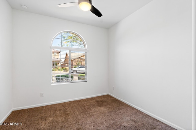 carpeted empty room with baseboards and ceiling fan