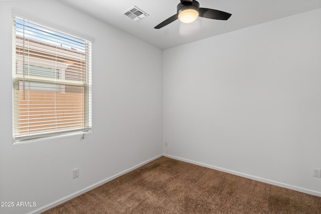 spare room with visible vents, baseboards, and carpet floors