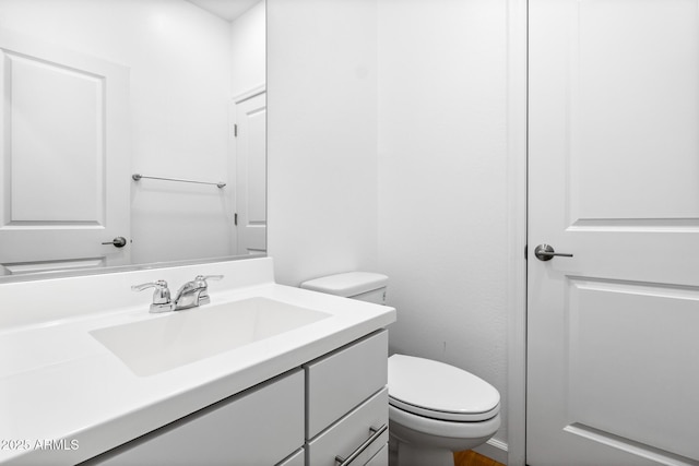 half bath with vanity and toilet