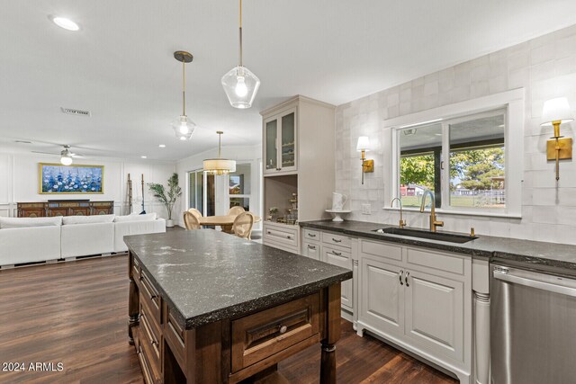 kitchen with white cabinets, dark hardwood / wood-style flooring, stainless steel dishwasher, dark brown cabinetry, and sink