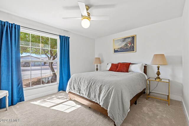 bedroom featuring light carpet and ceiling fan