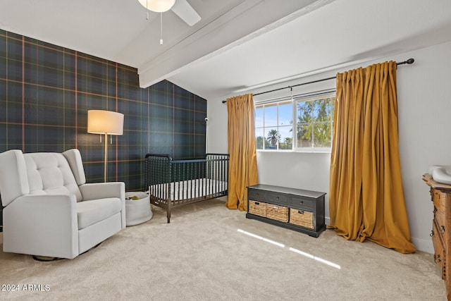 sitting room featuring ceiling fan, lofted ceiling with beams, and carpet