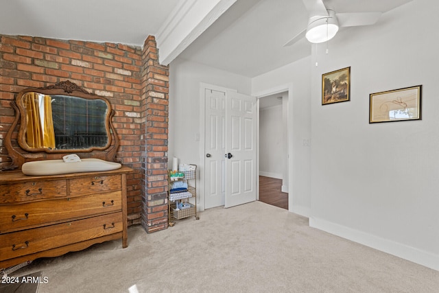 bedroom featuring ceiling fan, vaulted ceiling, and light colored carpet