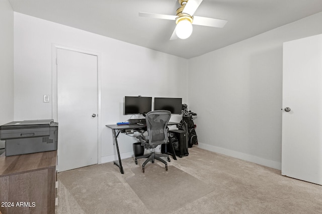 carpeted office space featuring ceiling fan