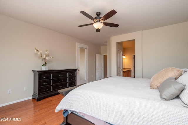 bedroom with ensuite bathroom, hardwood / wood-style floors, and ceiling fan