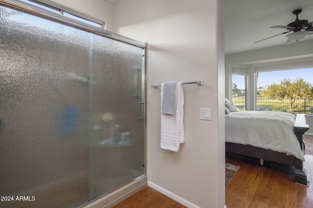 bathroom featuring hardwood / wood-style flooring, ceiling fan, and an enclosed shower