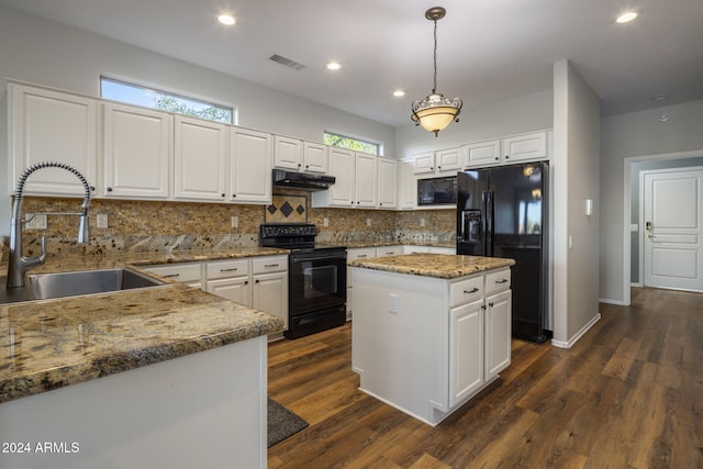 kitchen featuring pendant lighting, a center island, black appliances, white cabinets, and sink