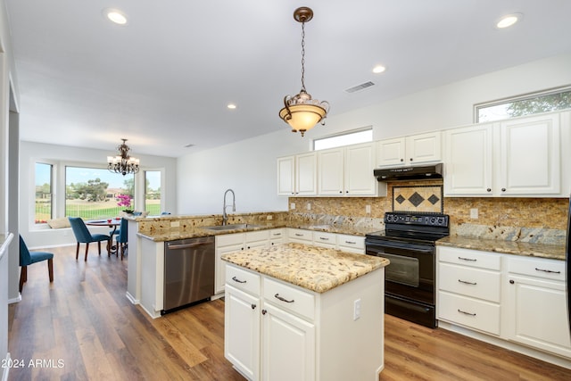 kitchen with black range with electric stovetop, sink, hanging light fixtures, stainless steel dishwasher, and kitchen peninsula