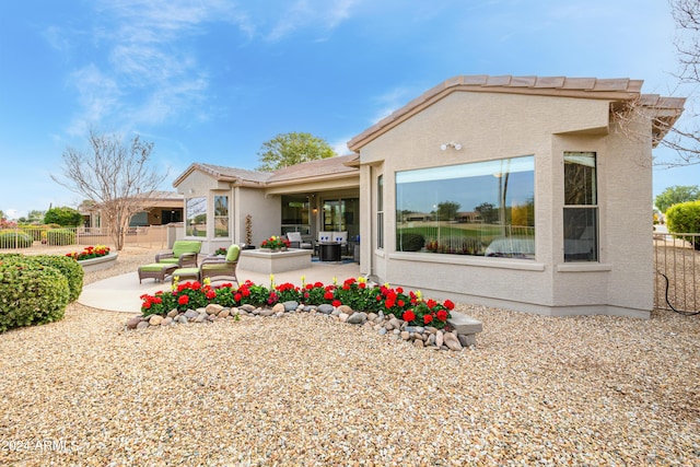 back of property with a patio