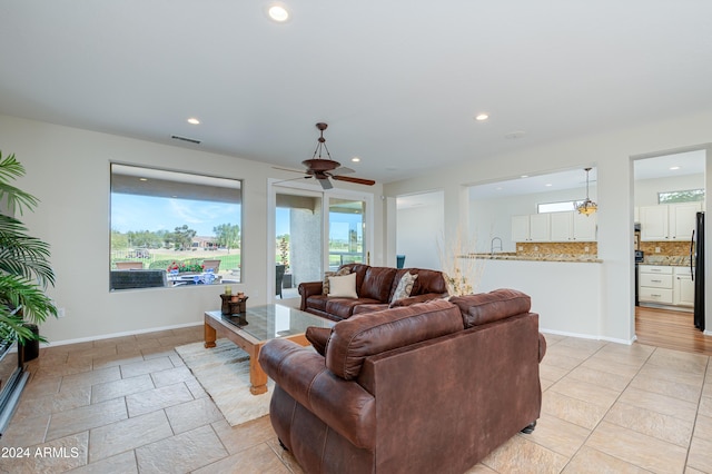 living room with ceiling fan and sink