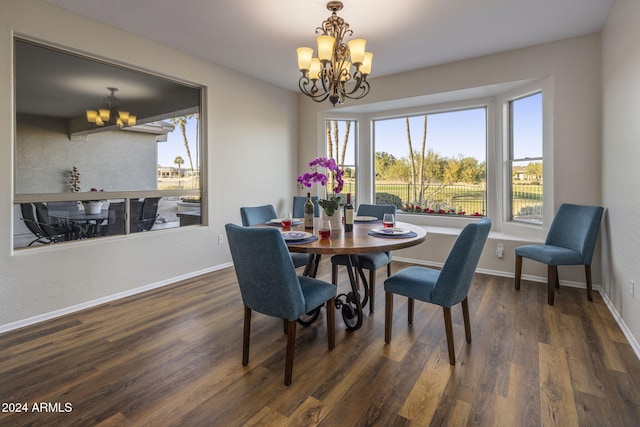 dining space with dark hardwood / wood-style floors and a notable chandelier