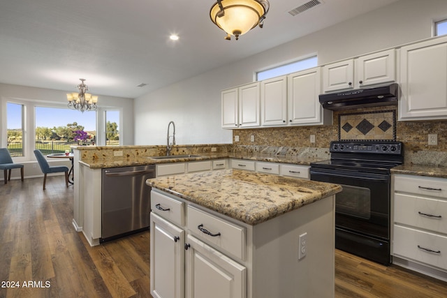 kitchen with hanging light fixtures, stainless steel dishwasher, decorative backsplash, black range with electric cooktop, and a kitchen island