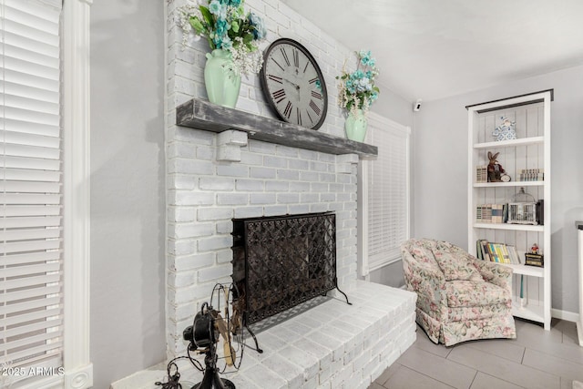 living area featuring tile patterned floors and a fireplace