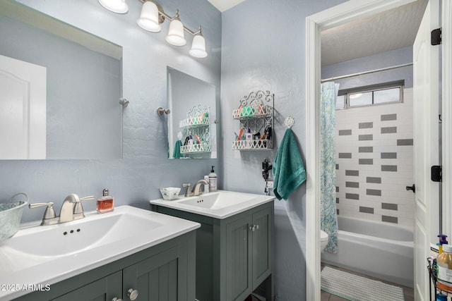 full bathroom with toilet, shower / bath combination with curtain, two vanities, and a sink