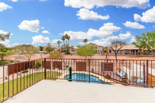 exterior space featuring fence and a residential view