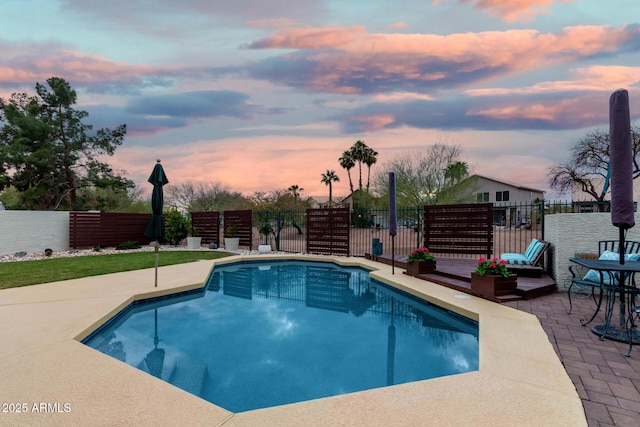 view of swimming pool featuring a patio area and fence