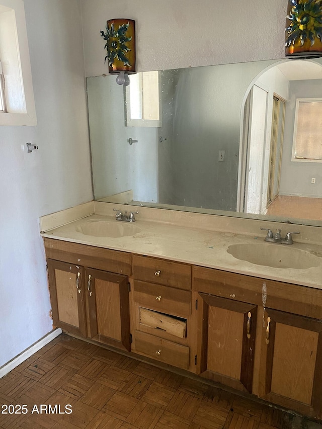 full bath featuring double vanity and a sink