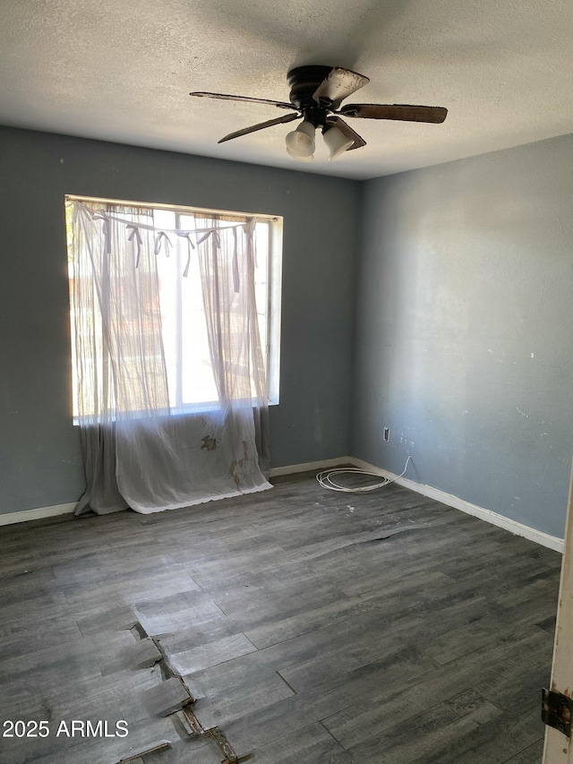 unfurnished room featuring a ceiling fan, a textured ceiling, baseboards, and wood finished floors