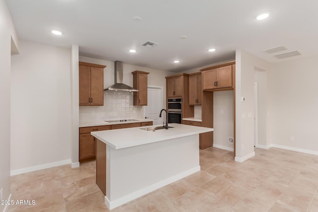 5678 N 205th Ln, Buckeye, AZ 85396 - kitchen with wall chimney exhaust hood, a sink, black electric cooktop, double oven, and brown cabinets