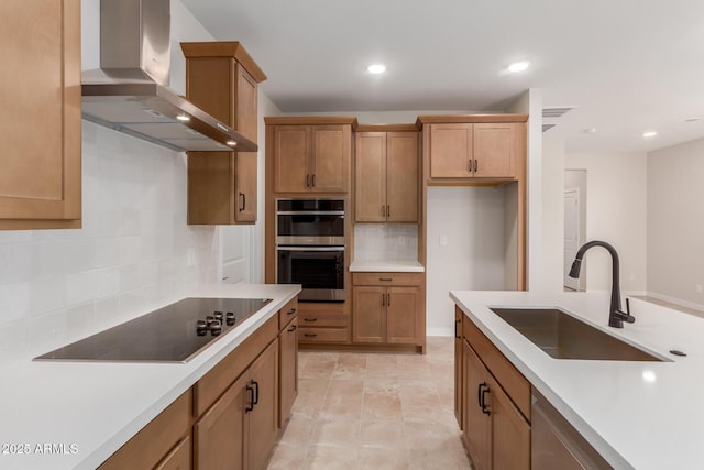 5678 N 205th Ln, Buckeye, AZ 85396 - kitchen with wall chimney exhaust hood, a sink, black electric cooktop, backsplash, and double oven