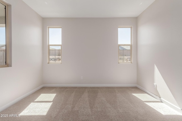 5678 N 205th Ln, Buckeye, AZ 85396 - empty room featuring light carpet and baseboards